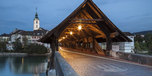 Covered bridge over Aare river in Olten at dawn. (Photo by: Loop Images/Universal Images Group via Getty Images)