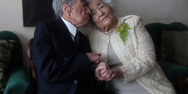 Couple Julio Mora Tapia, 110, and Valdramina Quinteros, 104, both retired teachers, pose for a photo at their home in Quito, Ecuador, on August 28 (AP Photo / Dolores Ochoa)