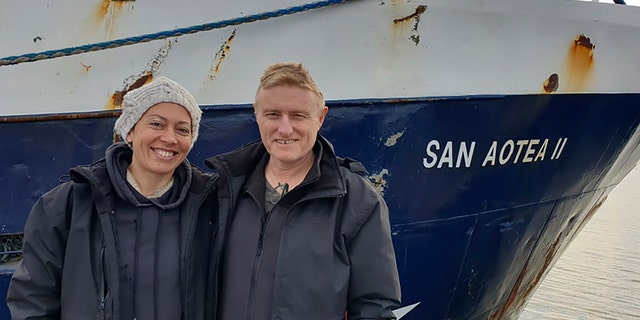 Neville and Feeonaa Clifton are pictured by the San Aotea II fishing boat in the Falkland Islands before embarking on their journey in July. (AP/Feeonaa and Neville Clifton)