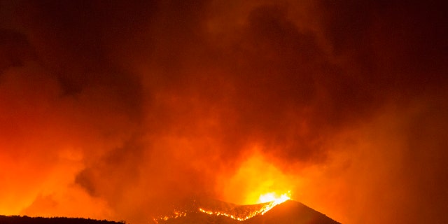 A brush fire burns at the Apple Fire in Banning, Calif., Saturday, Aug. 1, 2020.