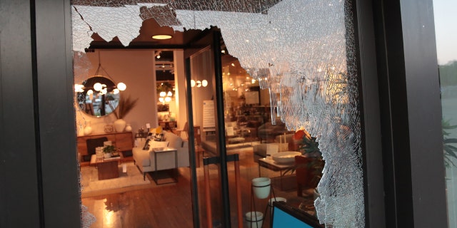 A broken storefront window is seen in Chicago early Monday. (Getty Images)