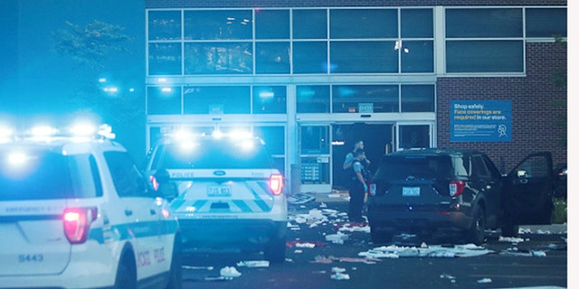 Police officers inspect a damaged Best Buy store in Chicago after parts of the city suffered widespread looting and vandalism. (Getty Images)