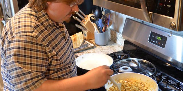 Clint Parry has been cooking at home more for his family throughout the COVID-19 pandemic. (Amanda Parry/Handout via REUTERS)