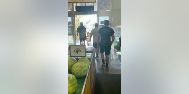 At one point, a young man identified as the disgruntled customer's son hoisted him up and carried him outside the store.