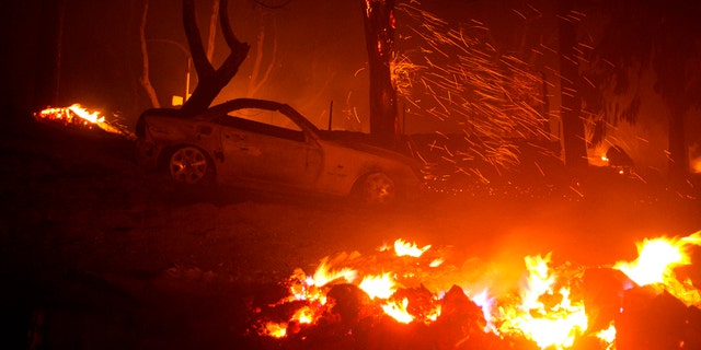 A burned vehicle is seen in the Lake Hughes fire in Angeles National Forest on Thursday, Aug. 13, 2020, north of Santa Clarita, Calif.