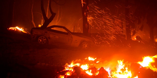 A burned vehicle is seen in the Lake Hughes fire in Angeles National Forest on Thursday, Aug. 13, 2020, north of Santa Clarita, Calif.
