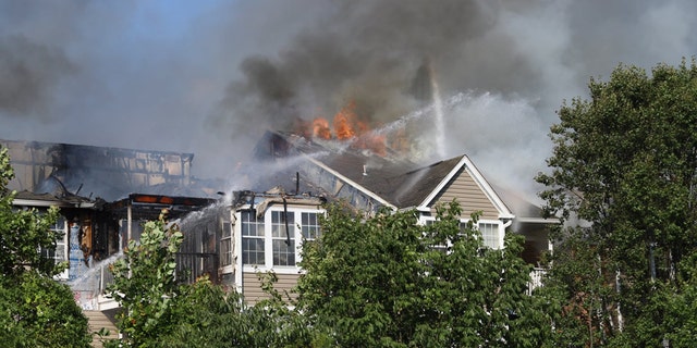 The three-story, garden-style complex was up in flames when first responders arrived at the scene, with heavy smoke and fire billowing from the rear from the structure.