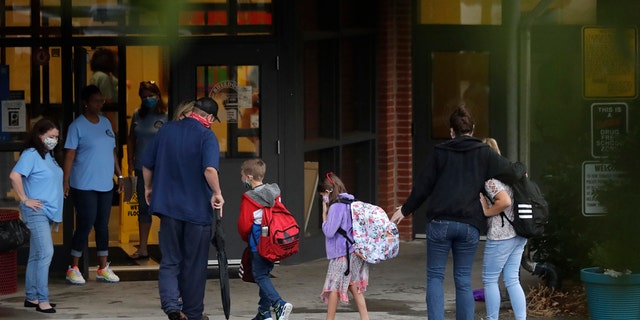 Students arrive at Dallas Elementary School in Dallas, Ga., for the first day of the 2020-21 school year amid the coronavirus outbreak. (AP Photo/Brynn Anderson)