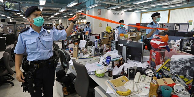 Hong Kong police arrested Lai and raided the publisher's headquarters Monday in the highest-profile use yet of the new national security law Beijing imposed on the city after protests last year. (Apple Daily via AP)