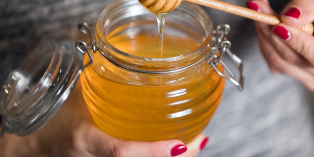 TikTok users have been uploading videos of themselves making bottles and containers full of frozen honey and consuming large globs of the sweet snack, which has sparked health experts to speak about the risks that come with eating excess honey or sugar. (iStock)