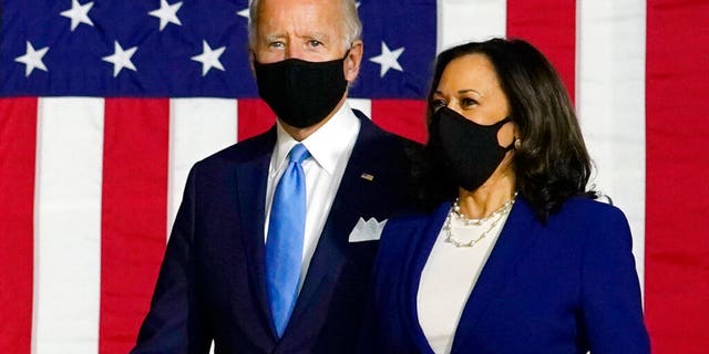 Democratic presidential candidate former Vice President Joe Biden and his running mate, Sen. Kamala Harris, D-Calif., arrive to speak at a news conference at Alexis Dupont High School in Wilmington, Del., Wednesday, Aug. 12, 2020. Biden and Harris both made comments suggesting Trump may push an unsafe coronavirus vaccine on the American people. (AP Photo/Carolyn Kaster)