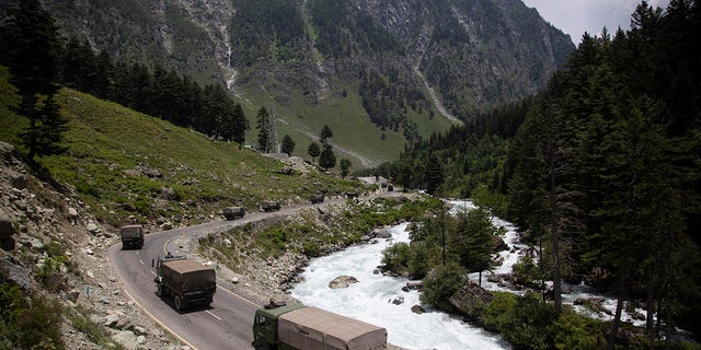 In this June 17, 2020, file photo, an Indian army convoy moves on the Srinagar- Ladakh highway at Gagangeer, northeast of Srinagar, India. (AP Photo/Mukhtar Khan, File)