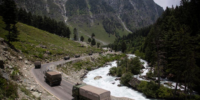 In this June 17, 2020, file photo, an Indian army convoy moves on the Srinagar- Ladakh highway at Gagangeer, northeast of Srinagar, India. (AP Photo/Mukhtar Khan, File)