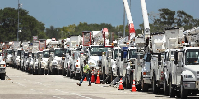 Dozens of utility trucks are lined up to be processed by Florida Power & Light at Daytona International Speedway on Saturday, Aug. 1, 2020.