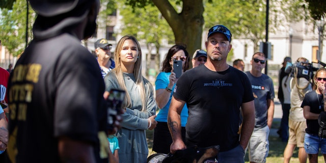 Blue Lives Matter supporters listening to Black Lives Matter supporter Nick Dennis during the rally in Kenosha.