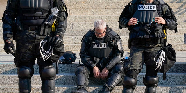 Police in riot gear stand outside the Kenosha County Court House Monday, Aug. 24, 2020, in Kenosha, Wis. Protests broke out late Sunday night after a police shooting. (AP Photo/Morry Gash)