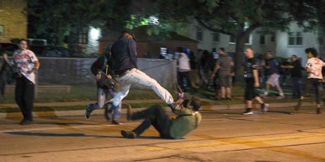 Fights breaking out during the third day of protests over the shooting of Jacob Blake in Kenosha, Wisconsin.