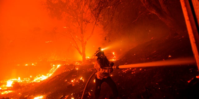 A firefighter works against the Lake Fire in Angeles National Forest on Wednesday. (AP)