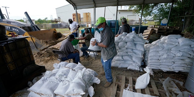 Municipal workers fill sandbags for the elderly and those with disabilities ahead of Hurricane Laura in Crowley, La., Tuesday, Aug. 25, 2020.