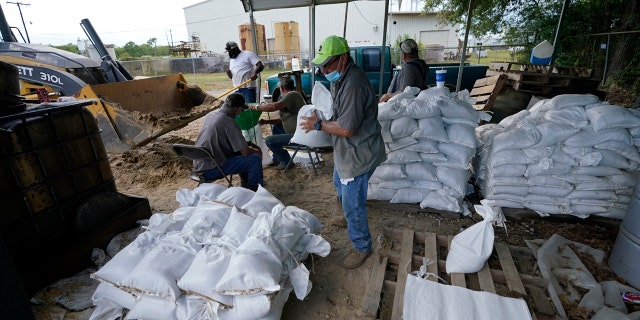 Municipal workers fill sandbags for the elderly and those with disabilities ahead of Hurricane Laura in Crowley, La., Tuesday, Aug. 25, 2020.