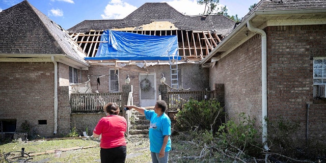 Homeowner Brenda Wilson, right, shows Cally Edwards of the American Red Cross the damage to the rear of her home on Woodard Road in rural Bertie County on Tuesday, August 4, 2020 near Windsor, N.C.