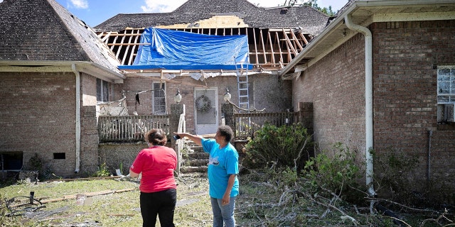 Homeowner Brenda Wilson, right, shows Cally Edwards of the American Red Cross the damage to the rear of her home on Woodard Road in rural Bertie County on Tuesday, August 4, 2020 near Windsor, N.C.