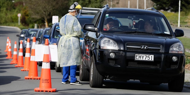 Medical staff prepare to take a COVID-19 test at a mobile testing site in Christchurch, New Zealand, on Thursday. (AP)