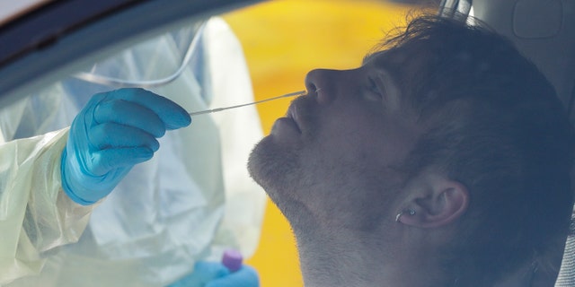 Health authorities in New Zealand are scrambling to trace the source of a new outbreak of the coronavirus as the nation's largest city, Auckland, goes back into lockdown. (AP)