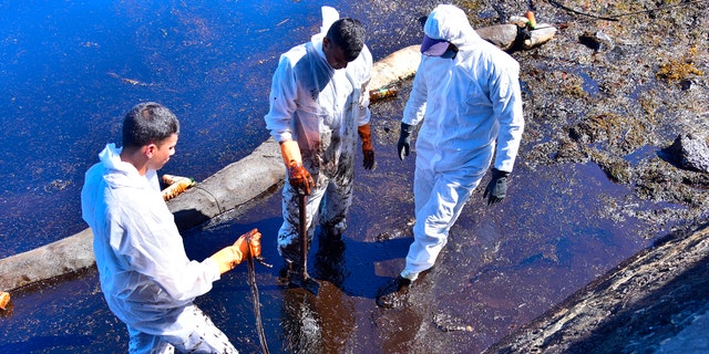 Volunteers take part in the clean up operation in Mahebourg, Mauritius Wednesday Aug. 12, 2020 surrounding the oil spill from the MV Wakashio.