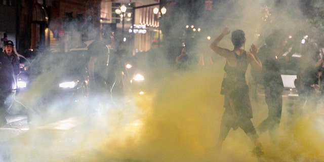 PORTLAND, OREGON, USA: Police confront demonstrators as Black Lives Matter supporters demonstrate in Portland, Oregon on July 4, 2020 for the thirty-eighth day in a row at Portland's Justice Center Photo by John Rudoff/Anadolu Agency via Getty Images)