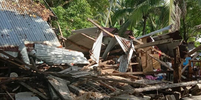 In this photo provided by the Philippine Red Cross, a toppled house is seen after a quake struck in Cataingan, Masbate province, central Philippines on Tuesday Aug. 18, 2020.