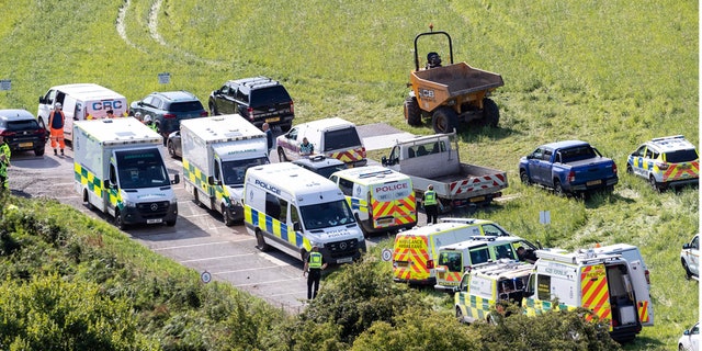 Emergency services attend the scene of a derailed train in Stonehaven, Scotland, Wednesday Aug. 12, 2020. (Derek Ironside/Newsline-media via AP)