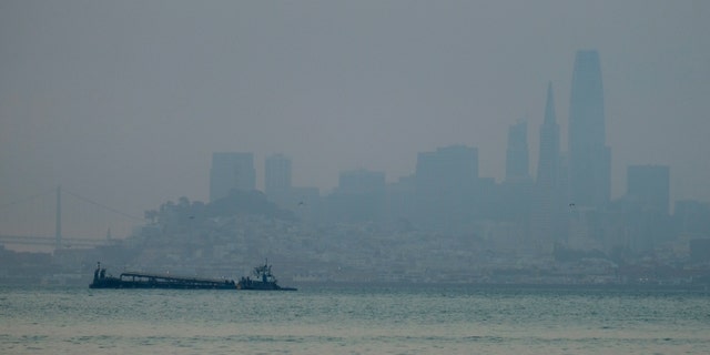 The San Francisco skyline is barely visible through smoke from wildfires Wednesday, Aug. 19, 2020, in this view from Sausalito, Calif. Thousands of people were under orders to evacuate in regions surrounding the San Francisco Bay Area Wednesday as nearly 40 wildfires blazed across the state amid a blistering heat wave now in its second week. Smoke blanketed the city of San Francisco. (AP Photo/Eric Risberg)