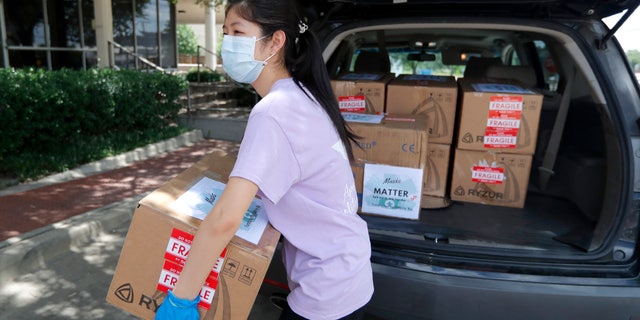 Valerie Xu, 15, delivers a donation, boxes of mask to UT Southwestern Medical Center in Dallas, Friday, June 5, 2020. Xu is among teens across the U.S. who decided to take action as the coronavirus pandemic took hold, doing everything from delivering groceries to older people to offering online tutoring, to emailing sick children and to raising money to help feed the hungry.