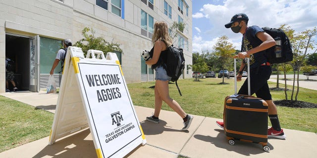 FILE - Evacuated students from Texas A&M University at Galveston are welcomed at Aloft College Station on Tuesday, Aug. 25, 2020, in College Station, Texas. Hurricane Laura is expected to make landfall late Wednesday or early Thursday. (Laura McKenzie/College Station Eagle via AP)