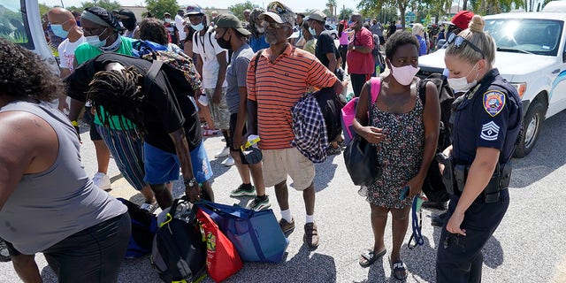 Residents wait to board buses to evacuate Tuesday in Galveston, Texas. The evacuees are being taken to Austin, Texas, as Hurricane Laura heads toward the Gulf Coast. (AP Photo/David J. Phillip)