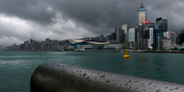 Rain droplets line a railing along the waterfront of Victoria Harbour in Hong Kong Wednesday, Aug. 19, 2020.