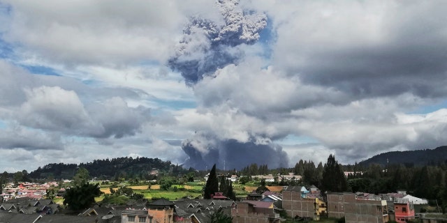 Mount Sinabung spews volcanic materials into the air as it erupts, in Karo, North Sumatra, Indonesia, Monday, Aug. 10, 2020.