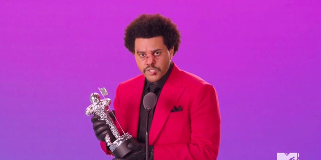 In this video grab issued Sunday, Aug. 30, 2020, by MTV, The Weeknd accepts the award for best R&amp;B video for "Blinding Lights" during the MTV Video Music Awards. (MTV via AP)