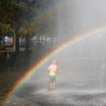 A young boy cools off under a rainbow in a fountain on a warm summer day in Hoboken, New Jersey, Aug. 11, 2020. (Photo by Gary Hershorn/Getty Images)
