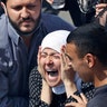 The wife of Rami Kaaki, one of ten firefighters who were killed during the last week's explosion that hit the seaport of Beirut, mourns during her husband's funeral at the firefighter headquarters, in Beirut, Lebanon, Aug. 11, 2020. 