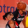 LeBron James of the Los Angeles Lakers drives the ball against Gary Trent Jr. of the Portland Trail Blazers during an NBA basketball first-round playoff game in Lake Buena Vista, Florida Aug. 18, 2020.