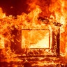 A mobile home and car burn at the Spanish Flat Mobile Villa as the LNU Lightning Complex fires tear through Napa County, California, Aug. 18, 2020. 