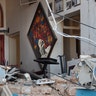 A woman stands inside a damaged restaurant a day after an explosion hit the seaport of Beirut, Lebanon, Aug. 5, 2020. 
