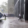People try to secure barriers meant to block flood waters that were picked up by the wind at a building at Water and State Streets in lower Manhattan Tuesday, Aug 4, 2020, as winds from Tropical Storm Isaias piked them up and tossed them about as the storm moved past, producing strong winds that at times causing damage.