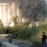 Lebanese security officers run to the explosion scene that hit the seaport, in Beirut, Lebanon, Tuesday, Aug. 4, 2020. 