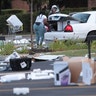 People load merchandise into a car near a looted Best Buy store after parts of the city had widespread looting and vandalism, on Aug. 10, 2020 in Chicago, Ill.