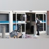Police officer inspects a damaged Best Buy store after parts of the city had widespread looting and vandalism, on Aug. 10, 2020 in Chicago, Ill.