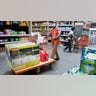 man, assistant operations manager, wheels a portable generator to the checkout stand for a customer at a Home Depot store as residents prepare for the possible landfall of Hurricane Laura on Tuesday, Aug. 25, 2020 in Houston. (Brett Coomer/Houston Chronicle via AP)