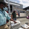 Animals from the Galveston Island Humane Society, are loaded onto Wings of Rescue plane with the help of Houston's SPCA for a flight to Dallas/Fort Worth as Hurricane Laura threatens the Texsa coast, Tuesday, Aug. 25, 2020, in Houston. (Steve Gonzales/Houston Chronicle via AP)